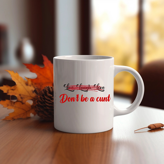 White mug on a table with "Live, Laugh, Love" original Nine-29 Design in black and red